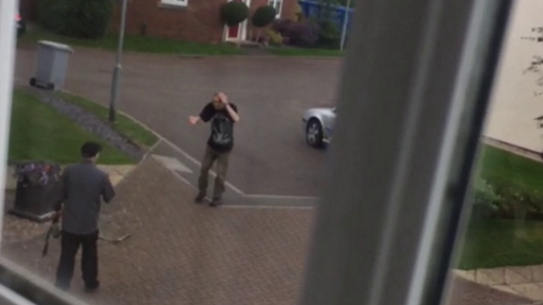 Neighbors caught on camera fighting each other with garden tools in quiet cul-de-sac